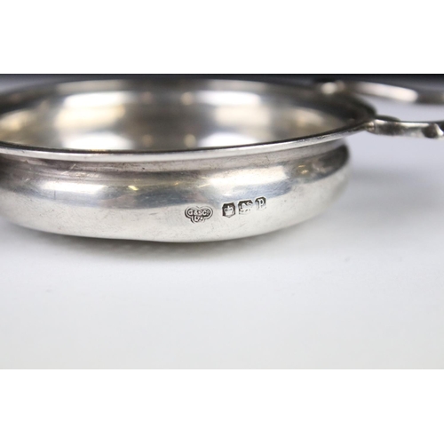 280 - A sterling silver twin handled tea strainer, assay marked for Sheffield.