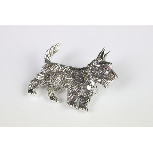 285 - A silver dog brooch set with a ruby eye.