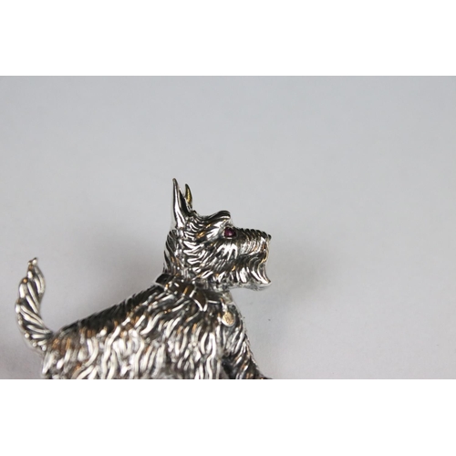 285 - A silver dog brooch set with a ruby eye.