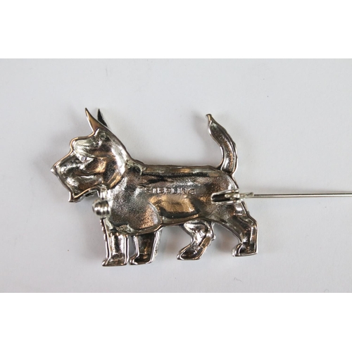 285 - A silver dog brooch set with a ruby eye.