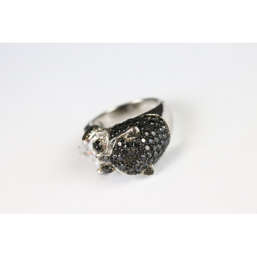 289 - A silver CZ and panther head designer style ring.