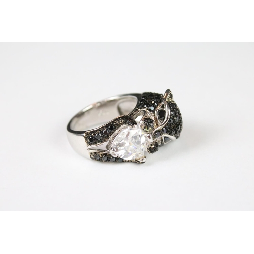 289 - A silver CZ and panther head designer style ring.