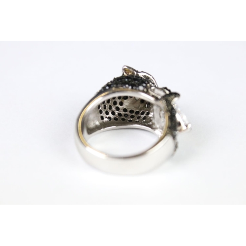 289 - A silver CZ and panther head designer style ring.