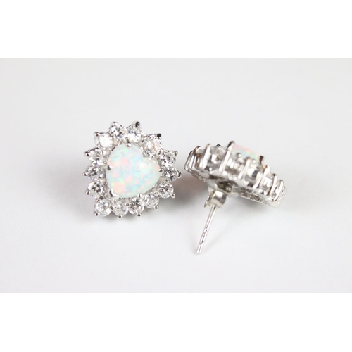 293 - A pair of silver CZ and opal panelled stud earrings.