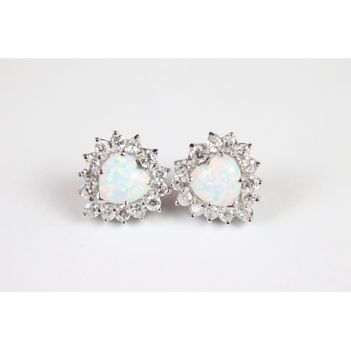 293 - A pair of silver CZ and opal panelled stud earrings.