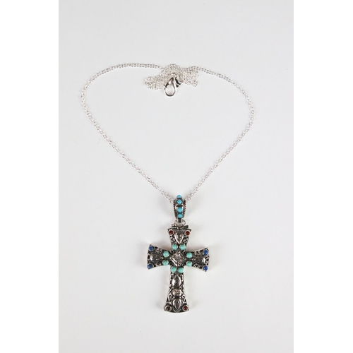 295 - A silver pendant cross set with turquoise and ruby cabochons.