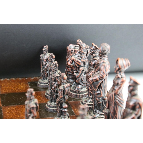 300 - A Wellington & Napoleon hand painted chess set together with chess board.