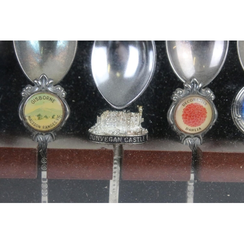 317 - A large collection of souvenir spoons contained within three collectors cabinets.