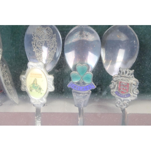 317 - A large collection of souvenir spoons contained within three collectors cabinets.