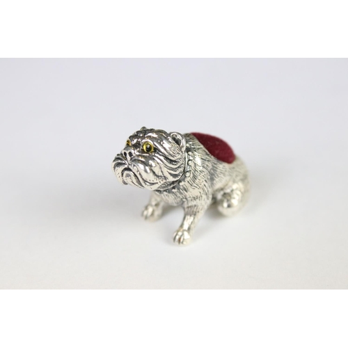 328 - A silver dog pincushion.