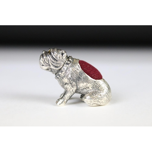 328 - A silver dog pincushion.