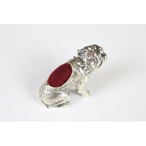 328 - A silver dog pincushion.