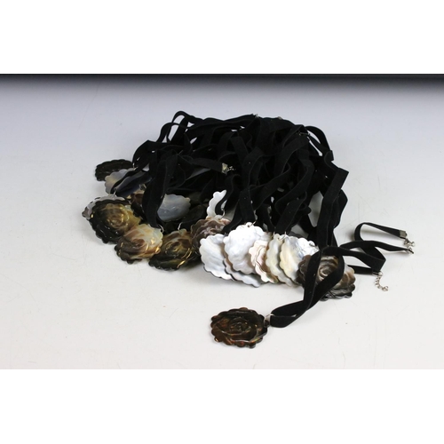 347 - A collection of thirty rose Mother of Pearl on velvet necklaces.