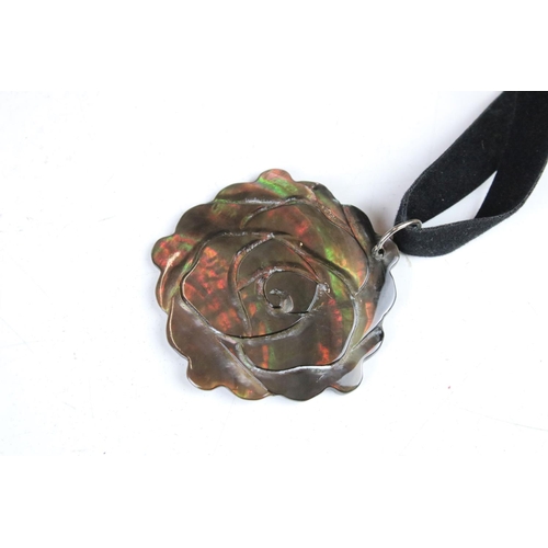 347 - A collection of thirty rose Mother of Pearl on velvet necklaces.