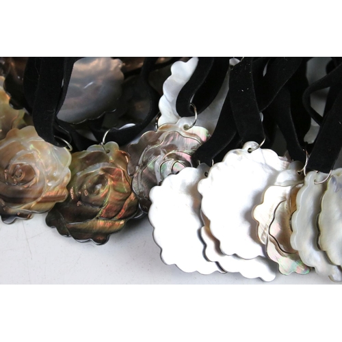 347 - A collection of thirty rose Mother of Pearl on velvet necklaces.