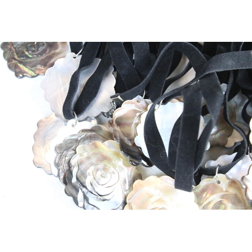 347 - A collection of thirty rose Mother of Pearl on velvet necklaces.