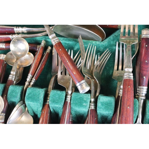 371 - A canteen of brass cutlery with polished wooden handles.