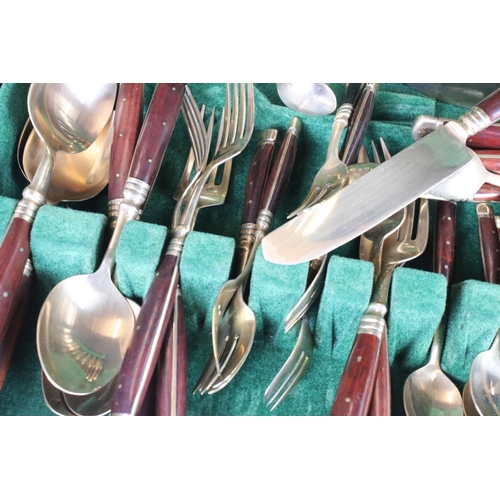 371 - A canteen of brass cutlery with polished wooden handles.