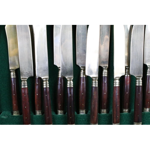 371 - A canteen of brass cutlery with polished wooden handles.