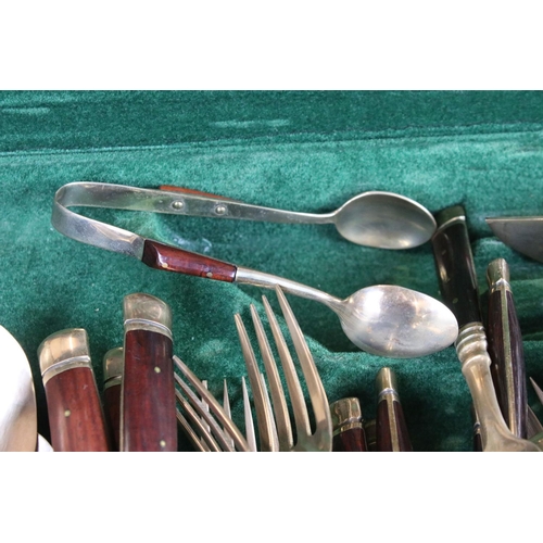 371 - A canteen of brass cutlery with polished wooden handles.