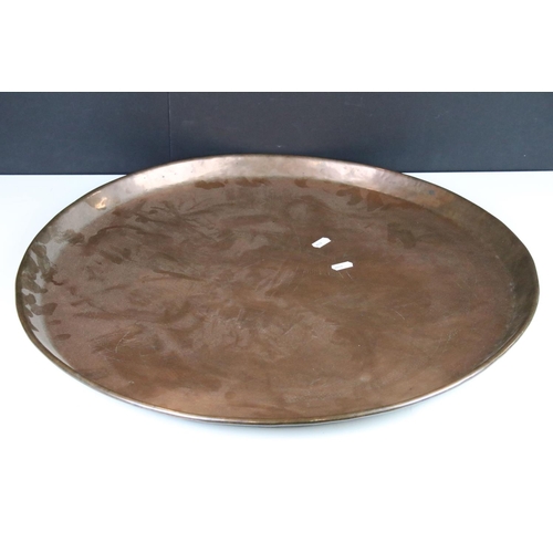 376 - A large copper charger with engraved decoration.