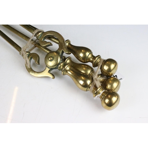 418 - A set of three brass fire irons, comprising: shovel poker, and tongs, the shovel 71cm long