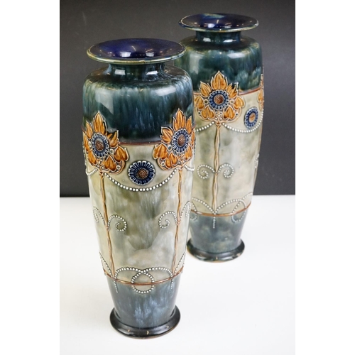 11 - Pair of Royal Doulton Art Nouveau vases of tapering form, relief decorated with stylised flowers, no... 