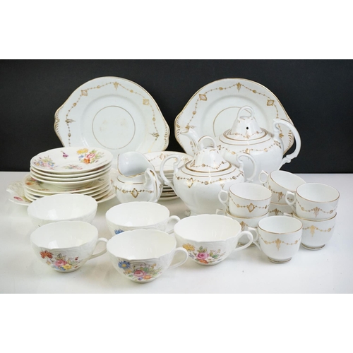 24 - 19th Century white ground & gilt tea set (teapot & cover, 7 teacups, 4 saucers, 5 tea plates, milk j... 