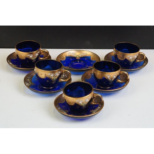 34 - Part-set of Bohemian Czech gilt blue glass cups & saucers, relief decorated with floral motifs, to i... 