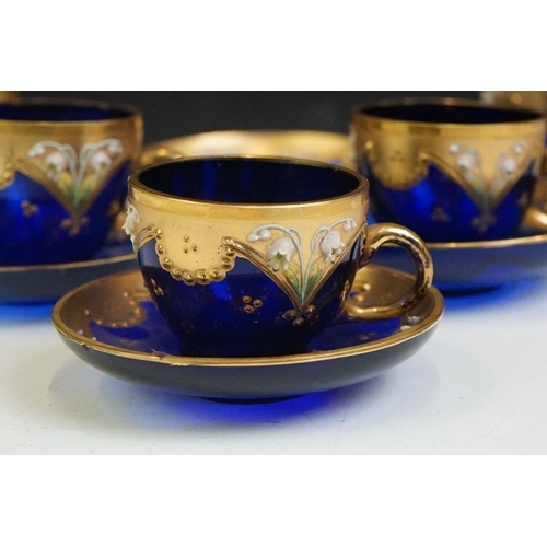 34 - Part-set of Bohemian Czech gilt blue glass cups & saucers, relief decorated with floral motifs, to i... 