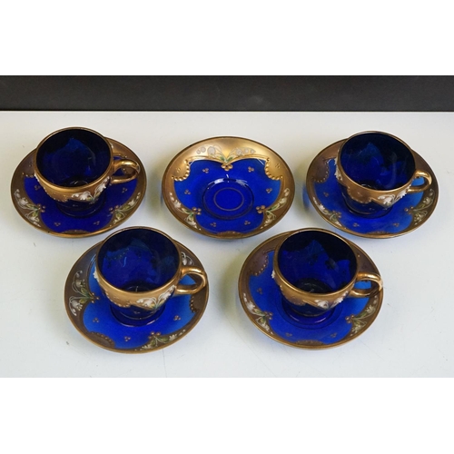 34 - Part-set of Bohemian Czech gilt blue glass cups & saucers, relief decorated with floral motifs, to i... 