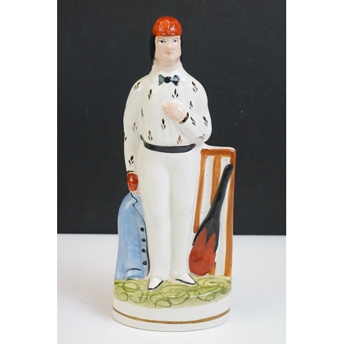 56 - Pair of Staffordshire pottery flatback cricketers, modelled as a batsman and bowler, approx 25cm hig... 