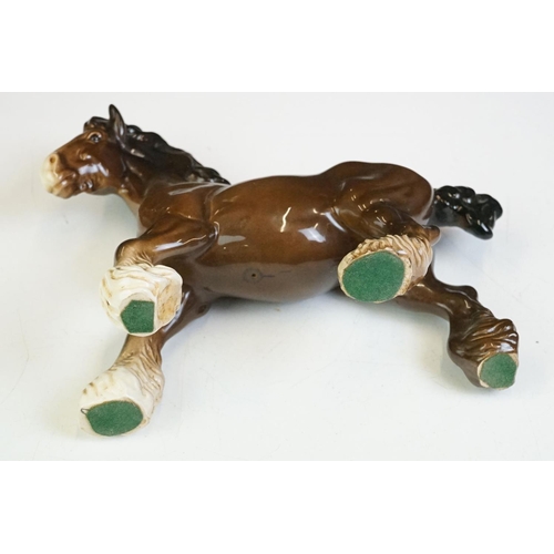 65 - Beswick - A Beswick Piebald Shire Mare with harness (appears overpainted, 21.5cm high), together wit... 