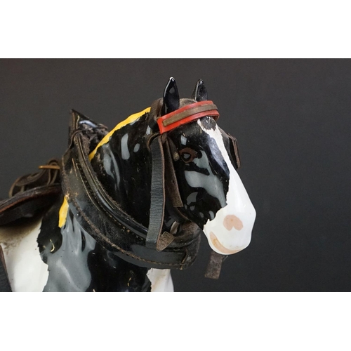 65 - Beswick - A Beswick Piebald Shire Mare with harness (appears overpainted, 21.5cm high), together wit... 