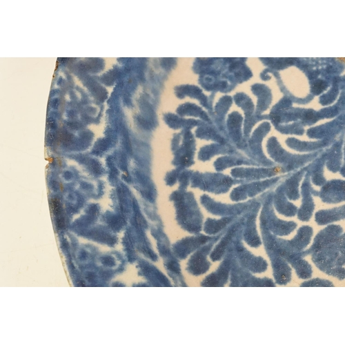 66 - 19th century blue & white pottery charger decorated with a bird amongst flora & fauna, 41cm diameter... 