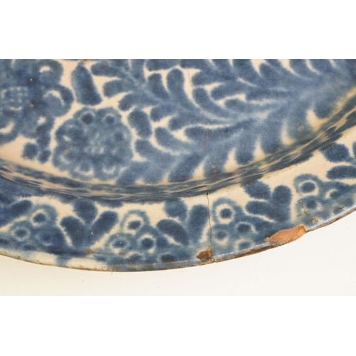 66 - 19th century blue & white pottery charger decorated with a bird amongst flora & fauna, 41cm diameter... 