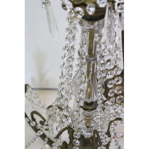 389 - An early 20th century brass six branch chandelier with glass droplet decoration.