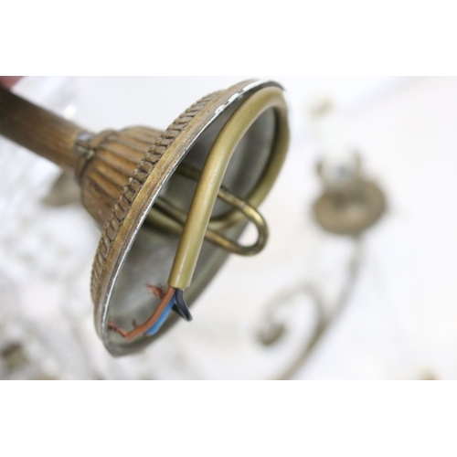 389 - An early 20th century brass six branch chandelier with glass droplet decoration.