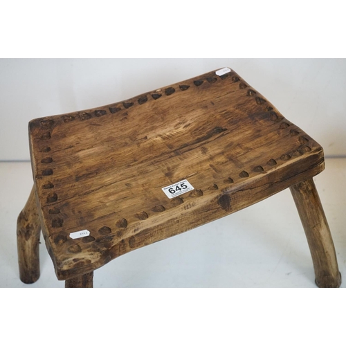 645 - Two Rustic Vernacular Stools, the smaller raised on three legs, largest stool measures 54cm long x 3... 