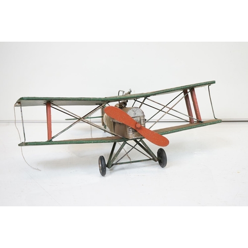 384 - A tinplate model of the Red Baron's Fokker trio plane, finish in red with iron cross insignia togeth... 