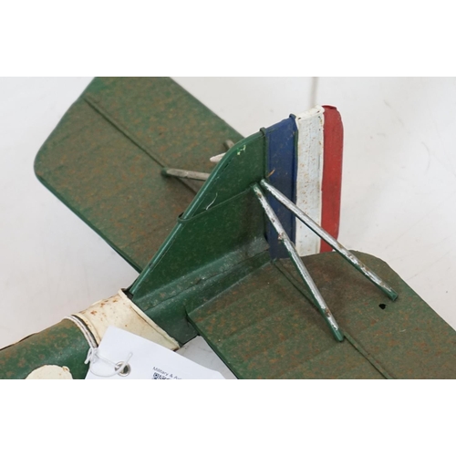384 - A tinplate model of the Red Baron's Fokker trio plane, finish in red with iron cross insignia togeth... 