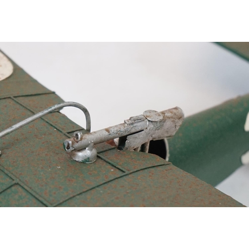 384 - A tinplate model of the Red Baron's Fokker trio plane, finish in red with iron cross insignia togeth... 