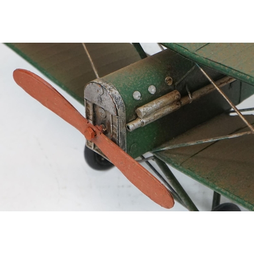 384 - A tinplate model of the Red Baron's Fokker trio plane, finish in red with iron cross insignia togeth... 