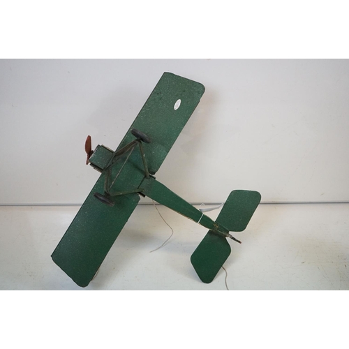 384 - A tinplate model of the Red Baron's Fokker trio plane, finish in red with iron cross insignia togeth... 