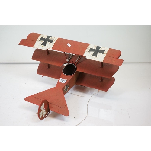 384 - A tinplate model of the Red Baron's Fokker trio plane, finish in red with iron cross insignia togeth... 