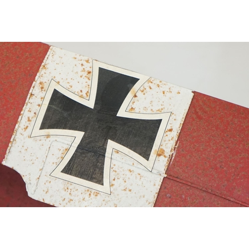 384 - A tinplate model of the Red Baron's Fokker trio plane, finish in red with iron cross insignia togeth... 