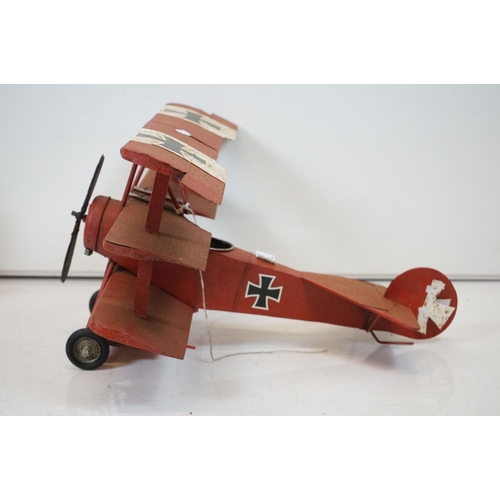 384 - A tinplate model of the Red Baron's Fokker trio plane, finish in red with iron cross insignia togeth... 