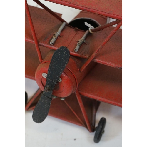384 - A tinplate model of the Red Baron's Fokker trio plane, finish in red with iron cross insignia togeth... 