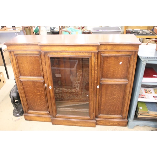 649 - Early 20th century Oak Breakfront Sideboard, the central glazed door opening to three adjustable she... 