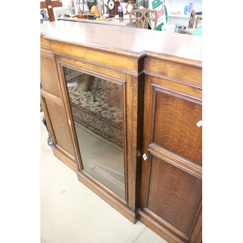 649 - Early 20th century Oak Breakfront Sideboard, the central glazed door opening to three adjustable she... 